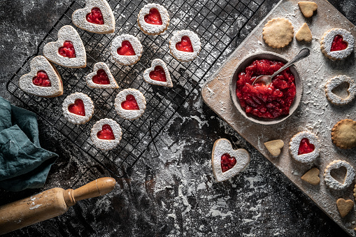 Linzer cookies biscuits food preparation with strawberry jam homemade Bakery heart shape