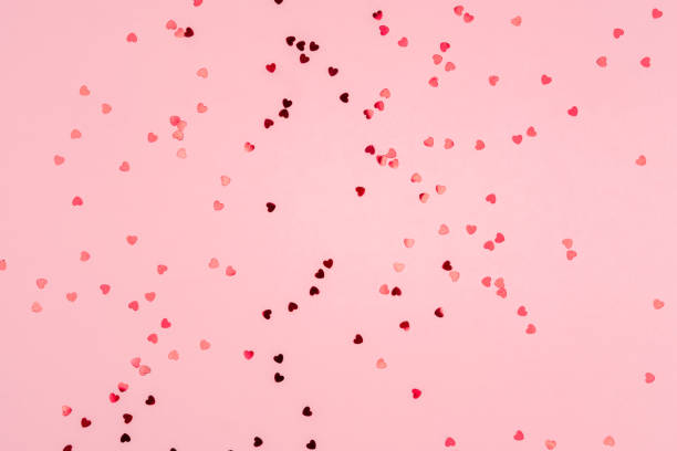 istock Pink background with glitter hearts for valentine's day. 1297008229