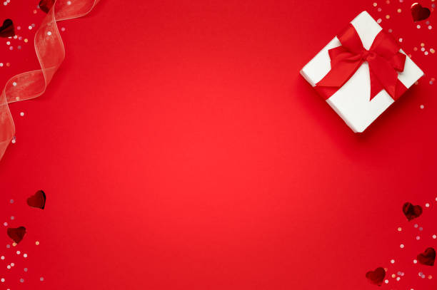 istock Gift box and soft hearts over red background. Template of Valentine's day 1297011067