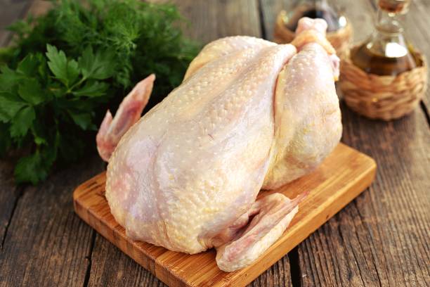 istock Fresh raw chicken on a wooden background. 1297011539