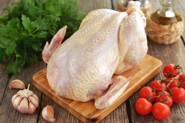 istock Fresh raw chicken on a wooden background. 1297011587