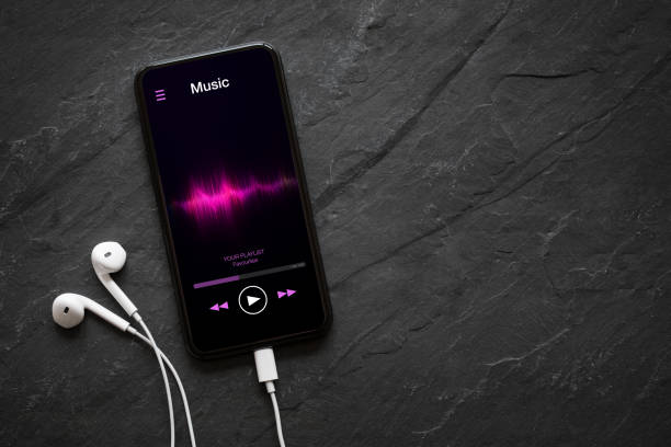 Music player on mobile phone with earphones Music player on mobile phone with earphones on black background headphones photos stock pictures, royalty-free photos & images