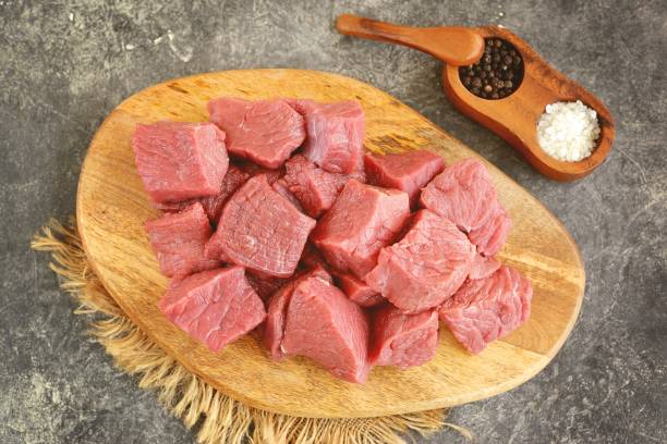 istock Fresh raw organic beef slices on a cutting board. 1297014665