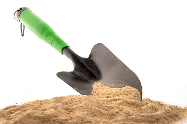 istock Green Spade in Sand for Gardening 1297014971