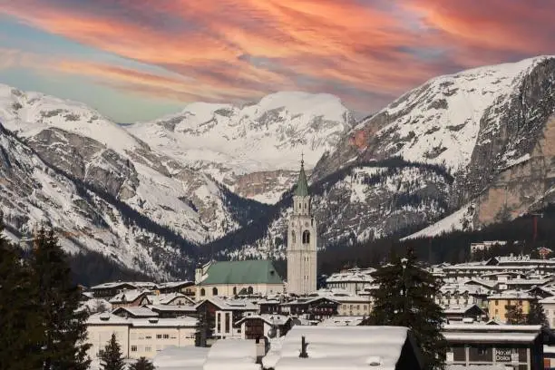 CORTINA D'AMPEZZO BELLUNO ITALIA GENNAIO 2021 Beautiful view of Cortina d'Ampezzo with its famous bell tower at sunset