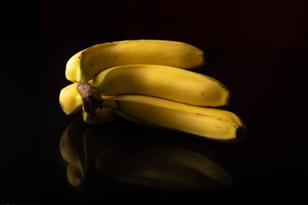 istock Bananas, arrangement with bananas on reflective surface, selective focus. 1297016006