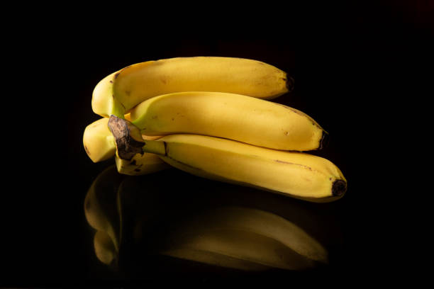 istock Bananas, arrangement with bananas on reflective surface, selective focus. 1297016045