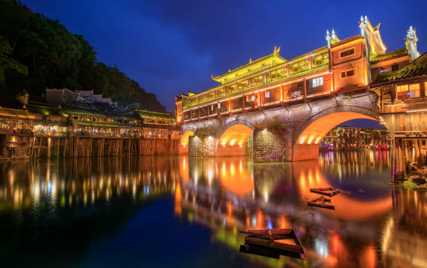 Hong bridge (Rainbow bridge) at night in Fenghuang old city ,Hunan Province, China Hong bridge (Rainbow bridge) at night in Fenghuang old city ,Hunan Province, China fenghuang county photos stock pictures, royalty-free photos & images