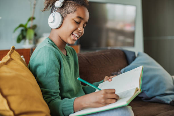 istock A little girl is writing homework 1297016428
