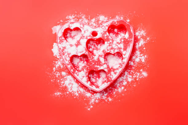 istock A silicone mold sprinkled with wheat flour for making holiday cupcakes on a red background. 1297016653