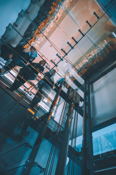 istock Business people walking on modern glass staircases 1297018447