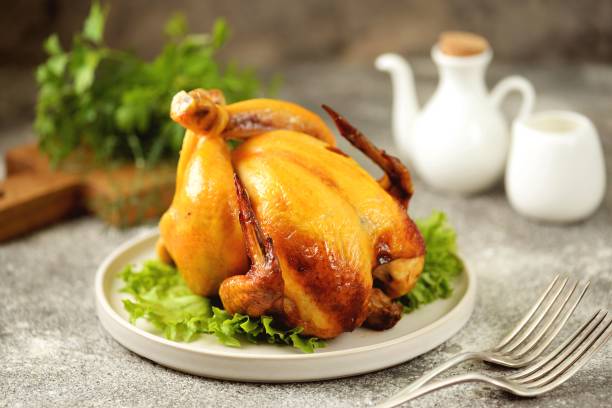 istock Grilled whole chicken on a gray background. 1297019317