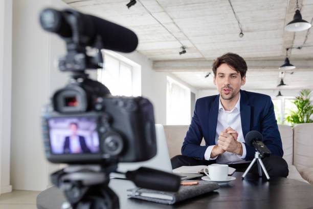 istock Businessman making a video blog in the office 1297019627