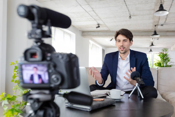 istock Businessman making a video blog in the office 1297019762