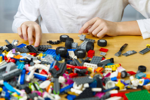 istock young boy playing with plastic construction toys at home. 1297020745