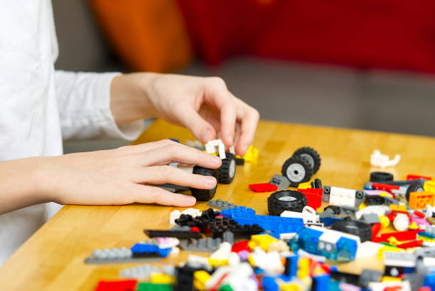 istock young boy playing with plastic construction toys at home. 1297020770