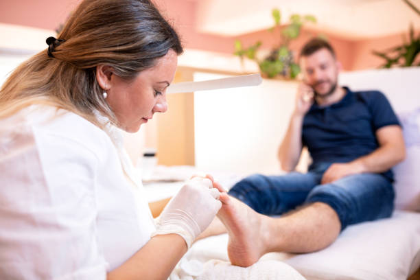 istock Pedicure spa worker taking care of her clients feet 1297022071