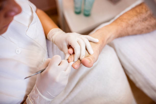 istock Cosmetician lady dealing with feet nail cuticles 1297022246