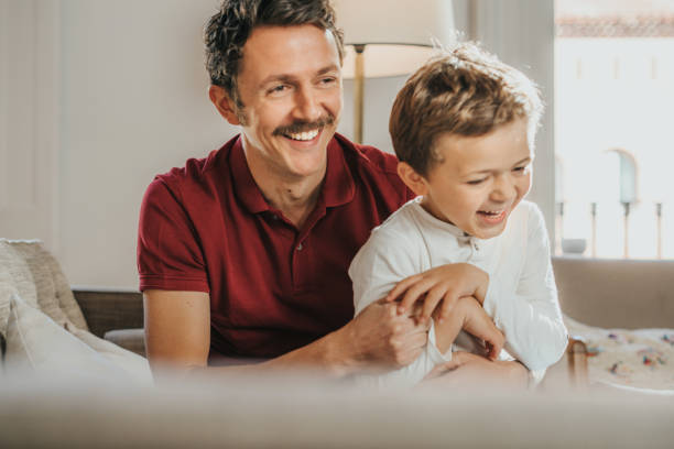 istock Father and son having fun at home 1297023596