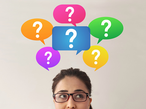 Confused young woman with question marks above her head