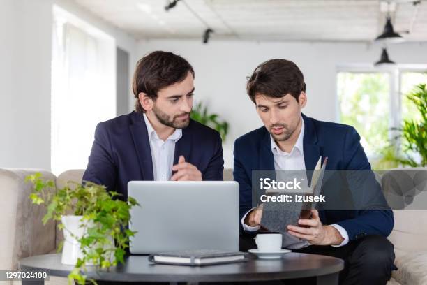 Two Businessmen Discussing In An Office Stock Photo - Download Image Now - 30-39 Years, Adult, Adults Only