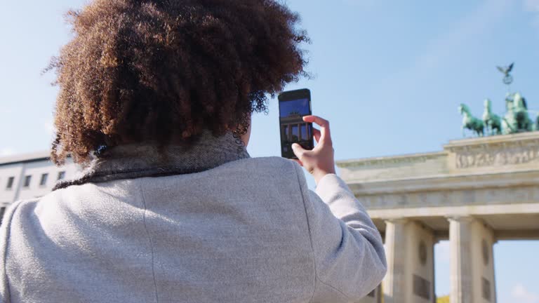 Traveler taking pictures of Brandenburg gate