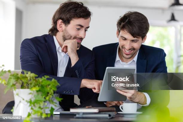 Two Cheerful Businessmen Working Together Stock Photo - Download Image Now - Shareholder, Social Issues, 30-39 Years