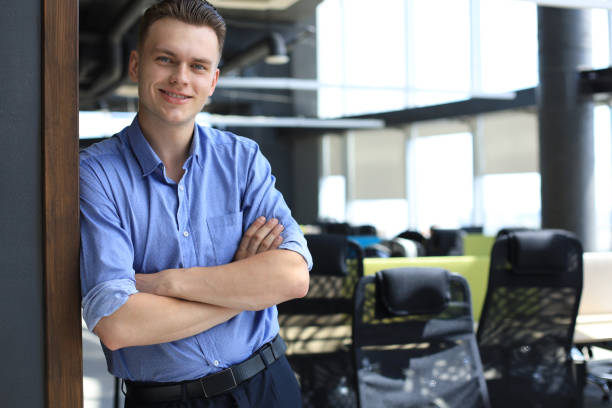 istock Young handsome businessman smiling in an office environment. 1297025791