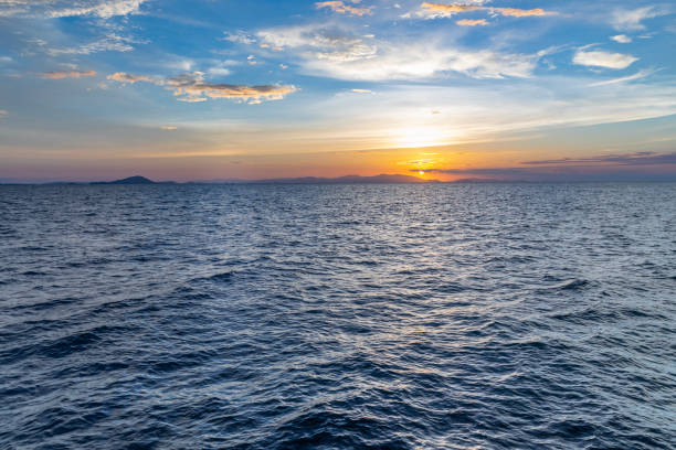 istock beautiful horizon on the ocean with dramatic clouds in the sky at sunset 1297026395