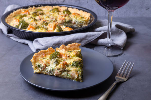 Kish (open pie) with trout, broccoli and cheese. Homemade unsweetened pastries, traditional pie. Quiche (open pie) with trout, broccoli and cheese. Homemade unsweetened pastries, traditional pie. Close-up. seafood gratin stock pictures, royalty-free photos & images