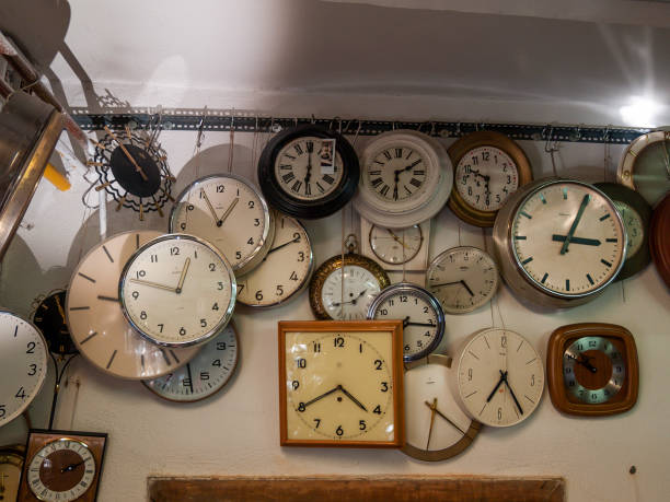 istock collection of vintage clocks hanging on a wall 1297028541