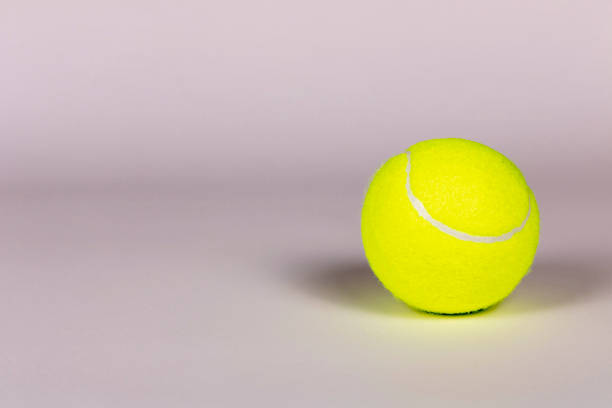 istock Yellow tennis ball on a light background. Close-up. 1297029920