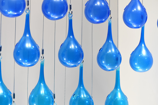 Blue glass bubble decoration tied rope hanging on ceiling