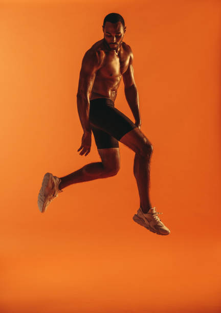 istock Muscular man jumping in air during workout 1297033152