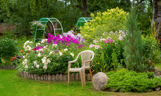 istock Beautiful garden with trees, lawn with green grass 1297033720