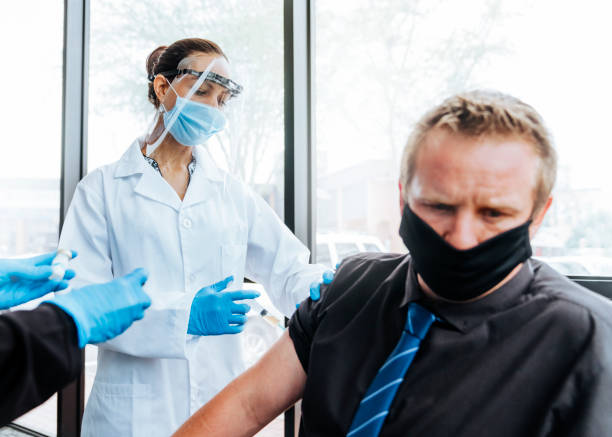 istock Doctor giving vaccine injection to scared man 1297033790