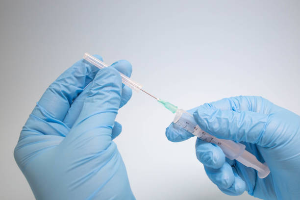 istock Preparing injection with covid-19 vaccine 1297033803