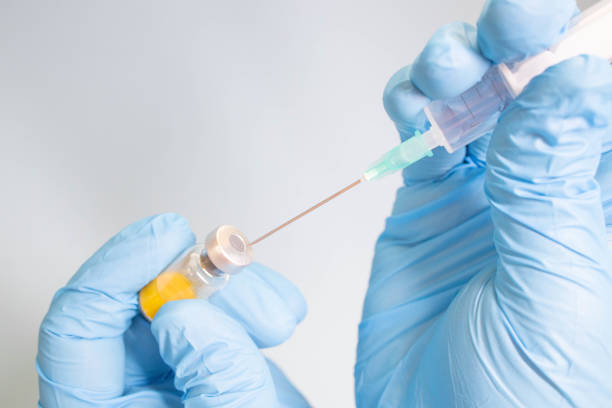 istock Preparing injection with covid-19 vaccine 1297033819