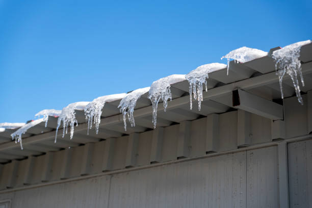 istock Winter icicles hanging from eaves of roof 1297034081