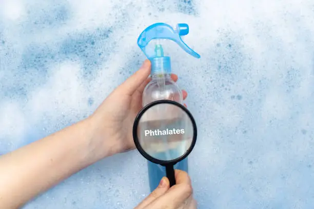 Photo of Air freshener floating in soapy water. Harmful composition of ingredients. Remedy with Phthalates. The concept of hazardous substances in cosmetics and household chemicals