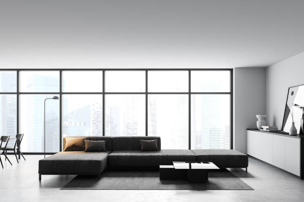 istock Modern white living room corner with sofa and window, side view 1297036579