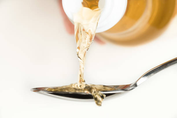 Pouring Rice Wine Vinegar on a Spoon stock photo