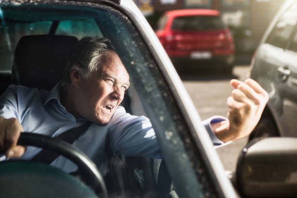 homem balança o punho e grita com raiva na estrada enquanto dirige um carro - furious road rage driver road - fotografias e filmes do acervo