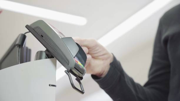 istock Pay for goods through the terminal in a contactless way in a supermarket. Using Modern and Convenient Wireless 1297039457