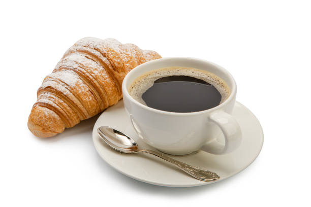 istock cup of coffee and croissant isolated on white background 1297040480