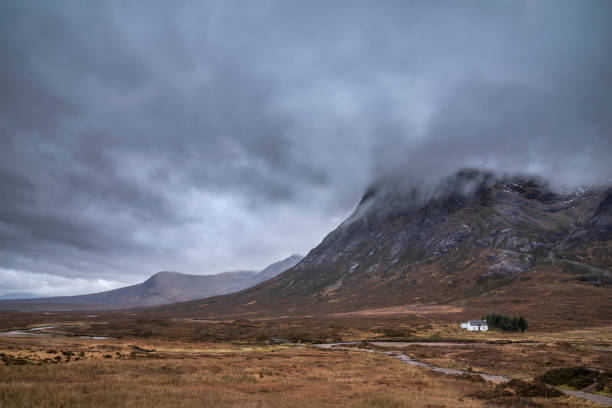 istock Majestic landscape image view down Glencoe Valley in Scottish Highlands with mountain ranges in dramatic Winter lighting 1297042994