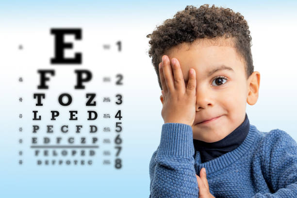 istock Little afro american boy doing vision test. 1297044364