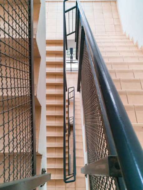 istock Top down view to modern staircase with light stairs and metal railings 1297046048