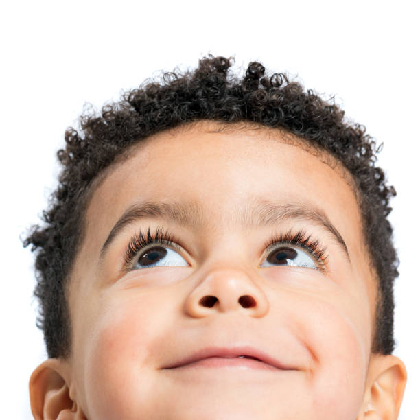 istock Macro close up of afro american boy looking at corner. 1297046862