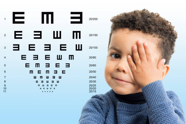 istock Little afro american kid having vision review with chart. 1297046911